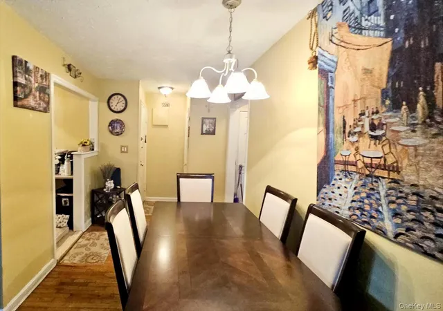 a view of a hallway with couches and dinning table