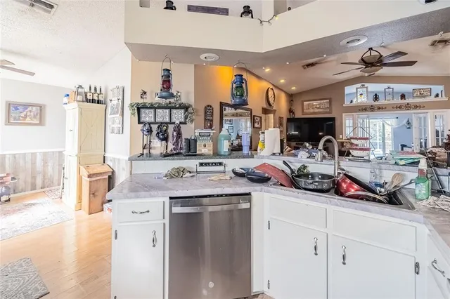 a kitchen with a sink appliances and cabinets