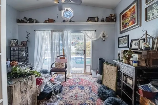 a spacious bedroom with a bed and a chandelier