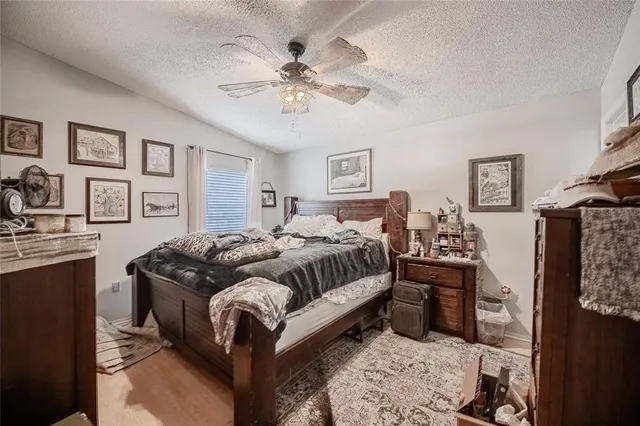 a bedroom with a large bed and a chandelier