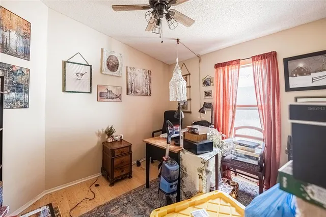 a living room with furniture a flat screen tv and a clock