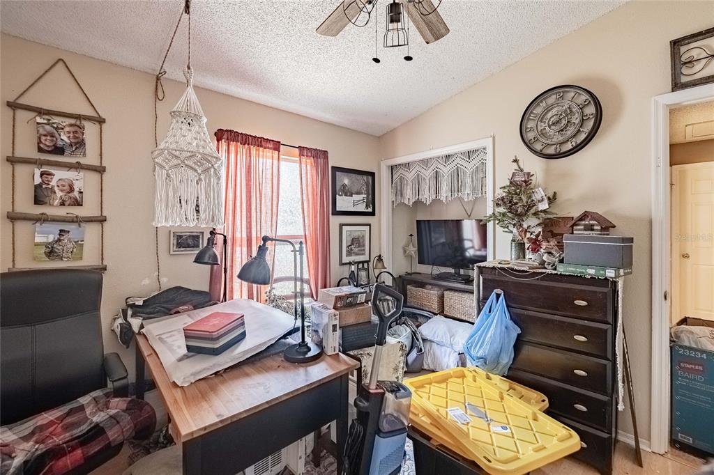 463 Emerald Cove Loop Lakeland, FL 33813 - Photo 21 of 30 a living room with furniture a flat screen tv and a clock