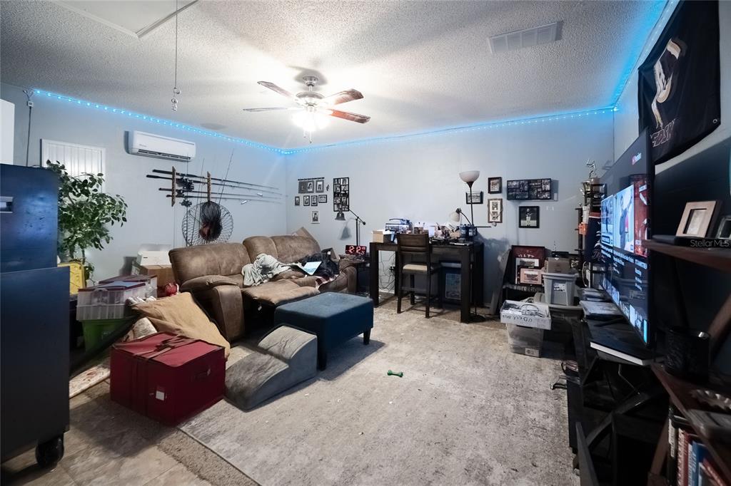 463 Emerald Cove Loop Lakeland, FL 33813 - Photo 24 of 30 a living room with furniture and a flat screen tv