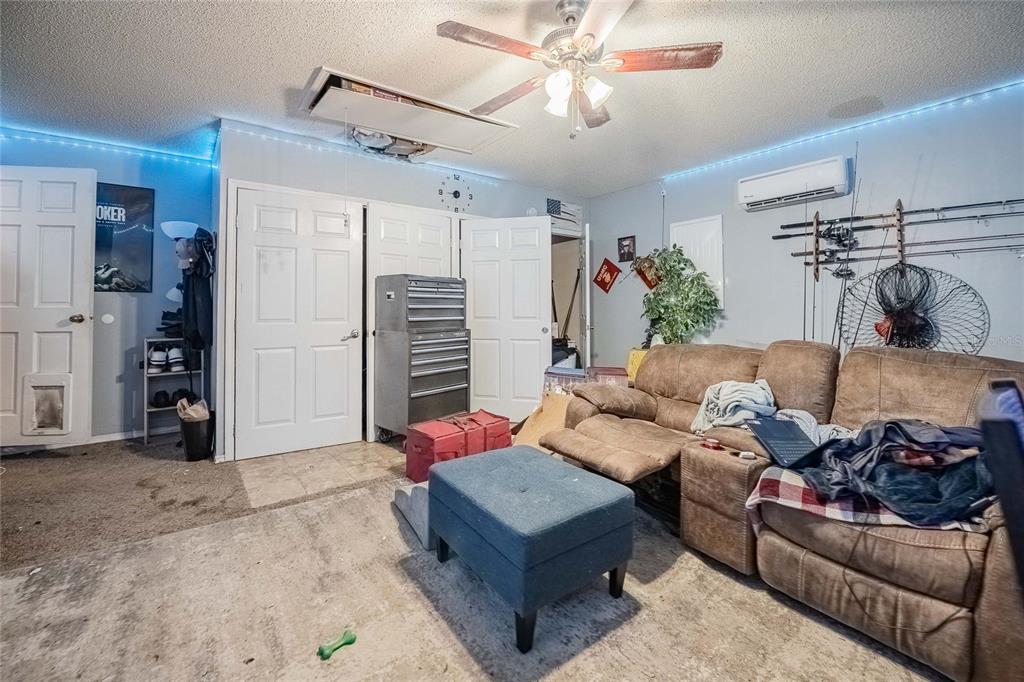 463 Emerald Cove Loop Lakeland, FL 33813 - Photo 25 of 30 a living room with furniture and a chandelier