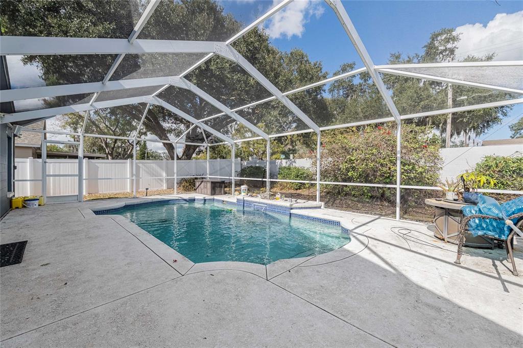 463 Emerald Cove Loop Lakeland, FL 33813 - Photo 26 of 30 a view of a backyard with a wooden fence