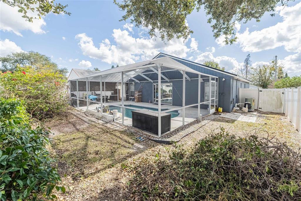 463 Emerald Cove Loop Lakeland, FL 33813 - Photo 28 of 30 a view of a house with wooden fence next to a yard