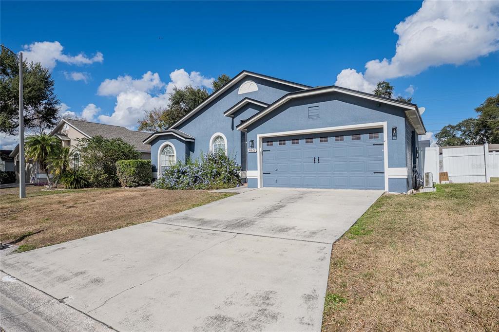 463 Emerald Cove Loop Lakeland, FL 33813 - Photo 5 of 30 a front view of a house with a yard and garage