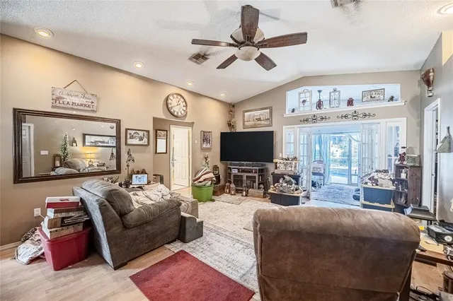 a living room with furniture a large window and a flat screen tv