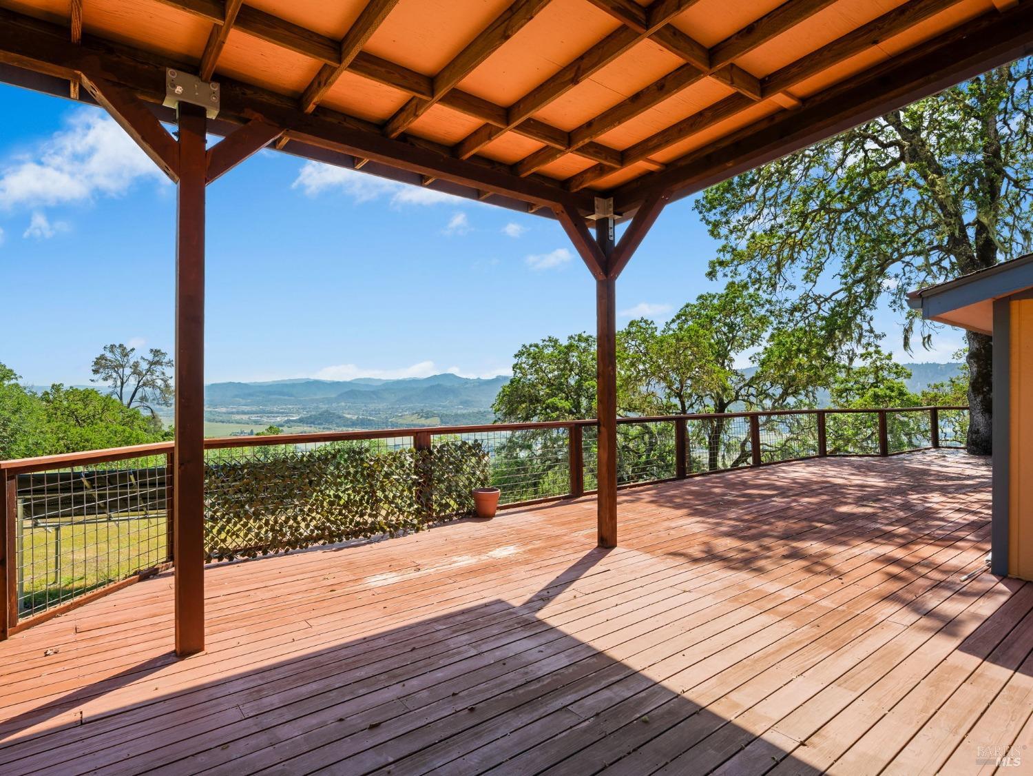 a view of a balcony with wooden floor