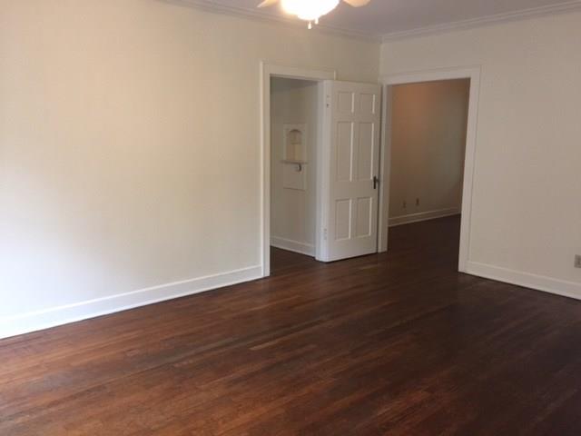 2915 Beanna Street Austin, TX 78705 - Photo 2 of 8 an empty room with wooden floor & windows