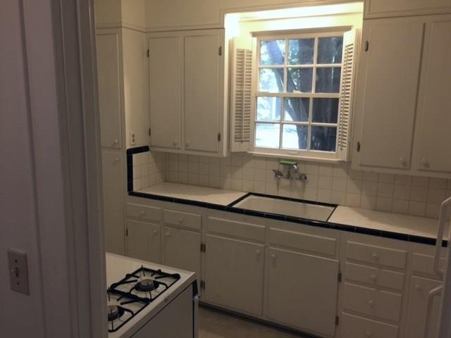 2915 Beanna Street Austin, TX 78705 - Photo 4 of 8 a kitchen with a sink and cabinets