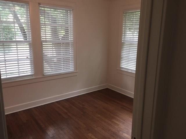 2915 Beanna Street Austin, TX 78705 - Photo 7 of 8 a view of an empty room with wooden floor and a window