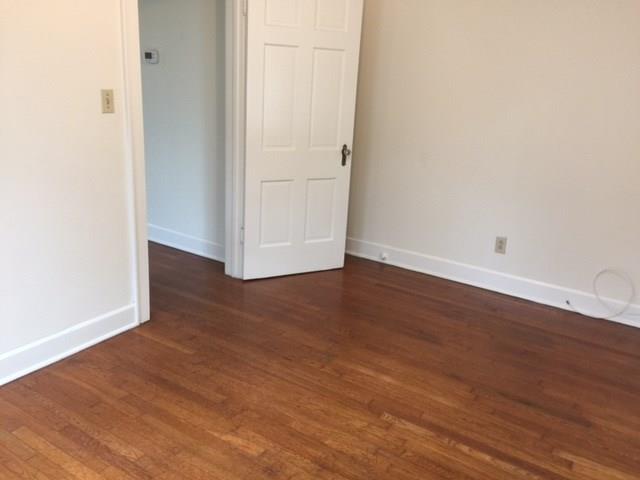 2915 Beanna Street Austin, TX 78705 - Photo 8 of 8 an empty room with wooden floor