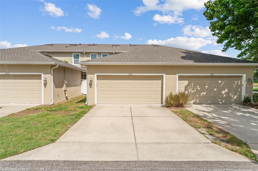 3523 Clay Brick Road St. Cloud, FL 34773 - Photo 33 of 62 a view of a house with a yard and a garage