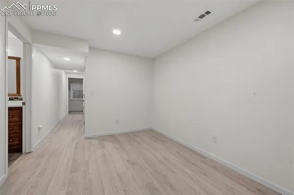 a view of hallway with wooden floor