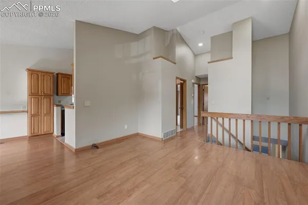 a view of hallway with wooden floor