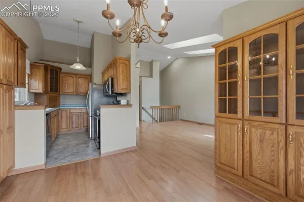 a view of a kitchen with furniture and wooden floor