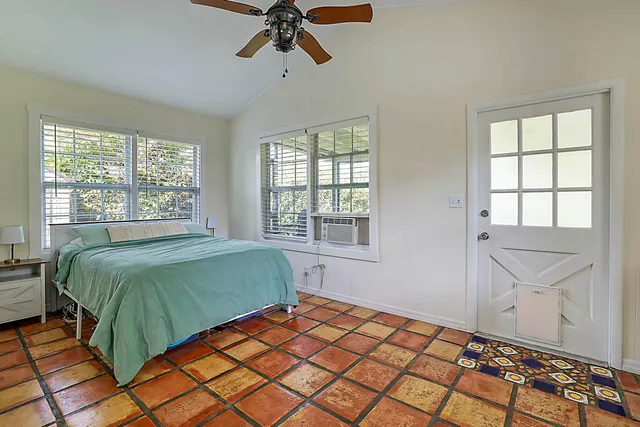 a bedroom with a bed and window