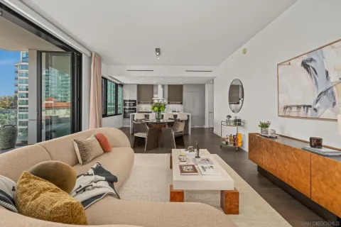 a living room with furniture fireplace and a large window