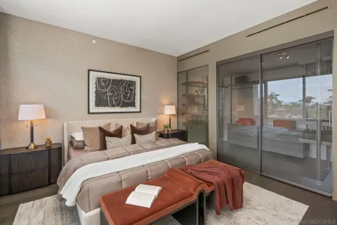 a bed sitting in a bedroom next to a window