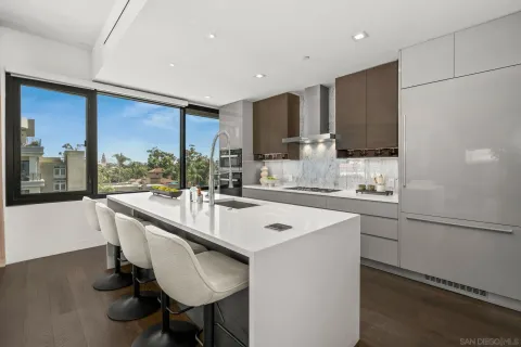 a kitchen with kitchen island a sink table and chairs
