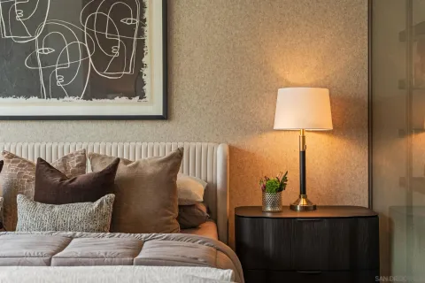 a spacious bedroom with a bed a couch and a large window