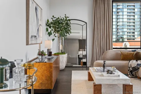 a dining room with kitchen island a dining table chairs with kitchen view and a chandelier