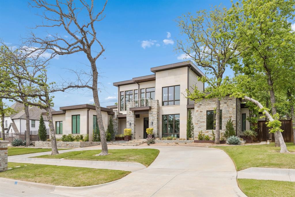 548 Oak Grove Lane Coppell, TX 75019 - Photo 2 of 36 a view of a white house with a yard and plants
