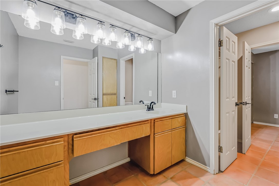 5917 Harvest Hill Road Corpus Christi, TX 78414 - Photo 30 of 40 a spacious bathroom with double vanity and a mirror