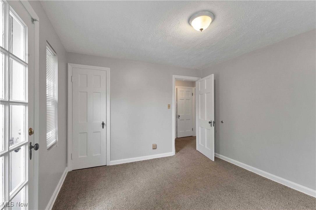 3385 Rosedale Road Cleveland, OH 44112 - Photo 20 of 40 Unfurnished bedroom with carpet, baseboards, and a textured ceiling