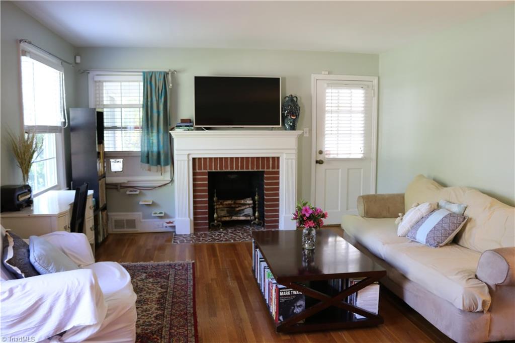 520 Polo Road Winston-Salem, NC 27106 - Photo 2 of 9 Living room with fireplace and access to the screened in porch.