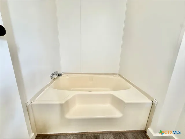 a bath tub sitting next to a white sink