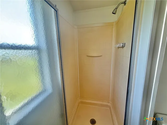 a bathroom with a shower and a sink