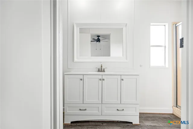 a bathroom with a toilet sink and a mirror