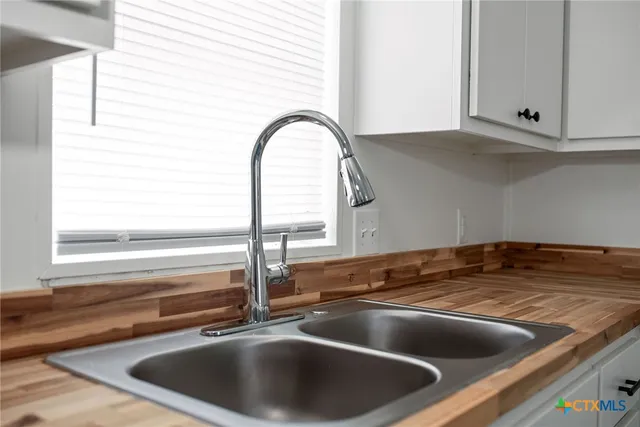 a kitchen with a stove and cabinets