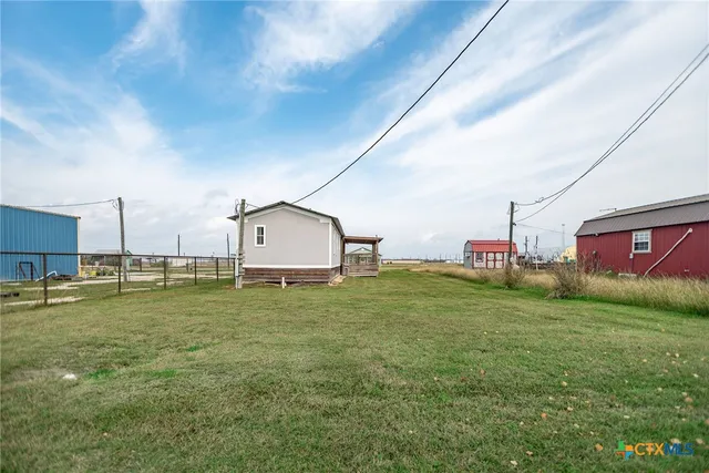 a backyard of a house with table and chairs
