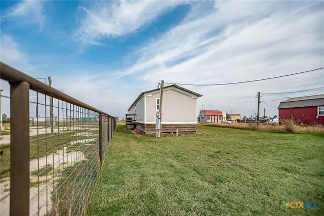 a view of a kitchen with wooden floor and a ceiling fan
