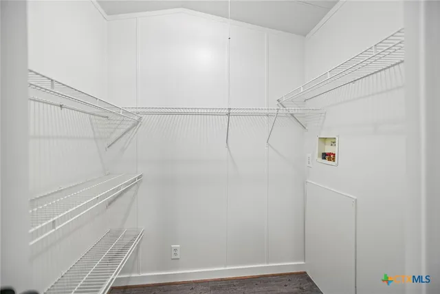 a kitchen with cabinets stainless steel appliances and a counter space