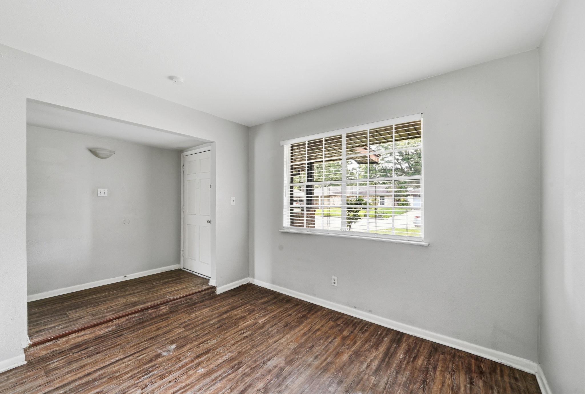 6410 Hopper Road Houston, TX 77016 - Photo 7 of 28 a view of an empty room with wooden floor and a window
