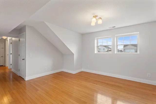 a view of a room with wooden floor and chandelier