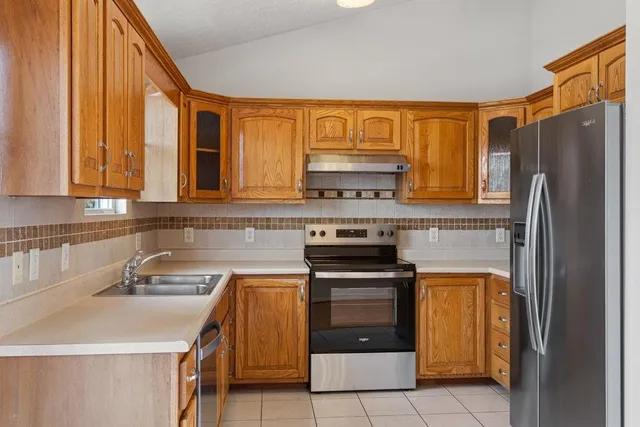 a kitchen with a sink a stove and refrigerator