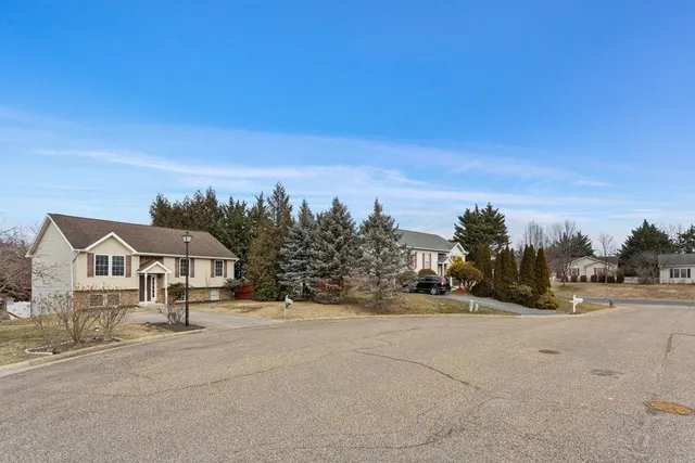 a view of staircase with wooden floor and white walls