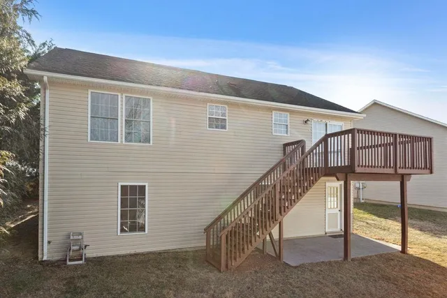 a balcony with wooden floor and fence