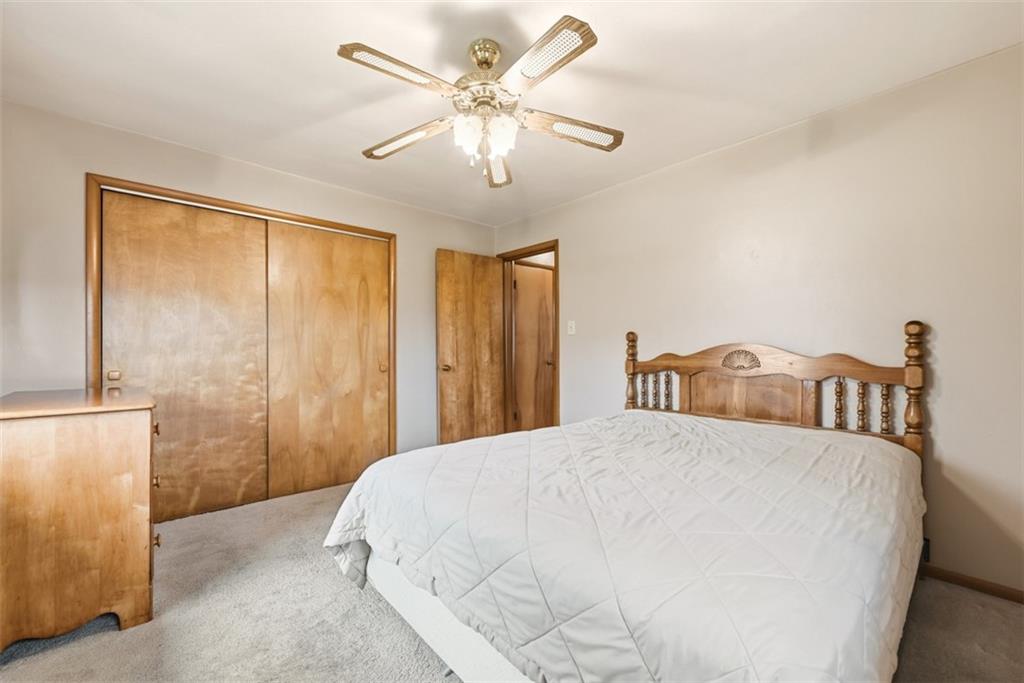 42 Lee Avenue Washington, PA 15301 - Photo 26 of 48 a bedroom with a large bed and a chandelier fan