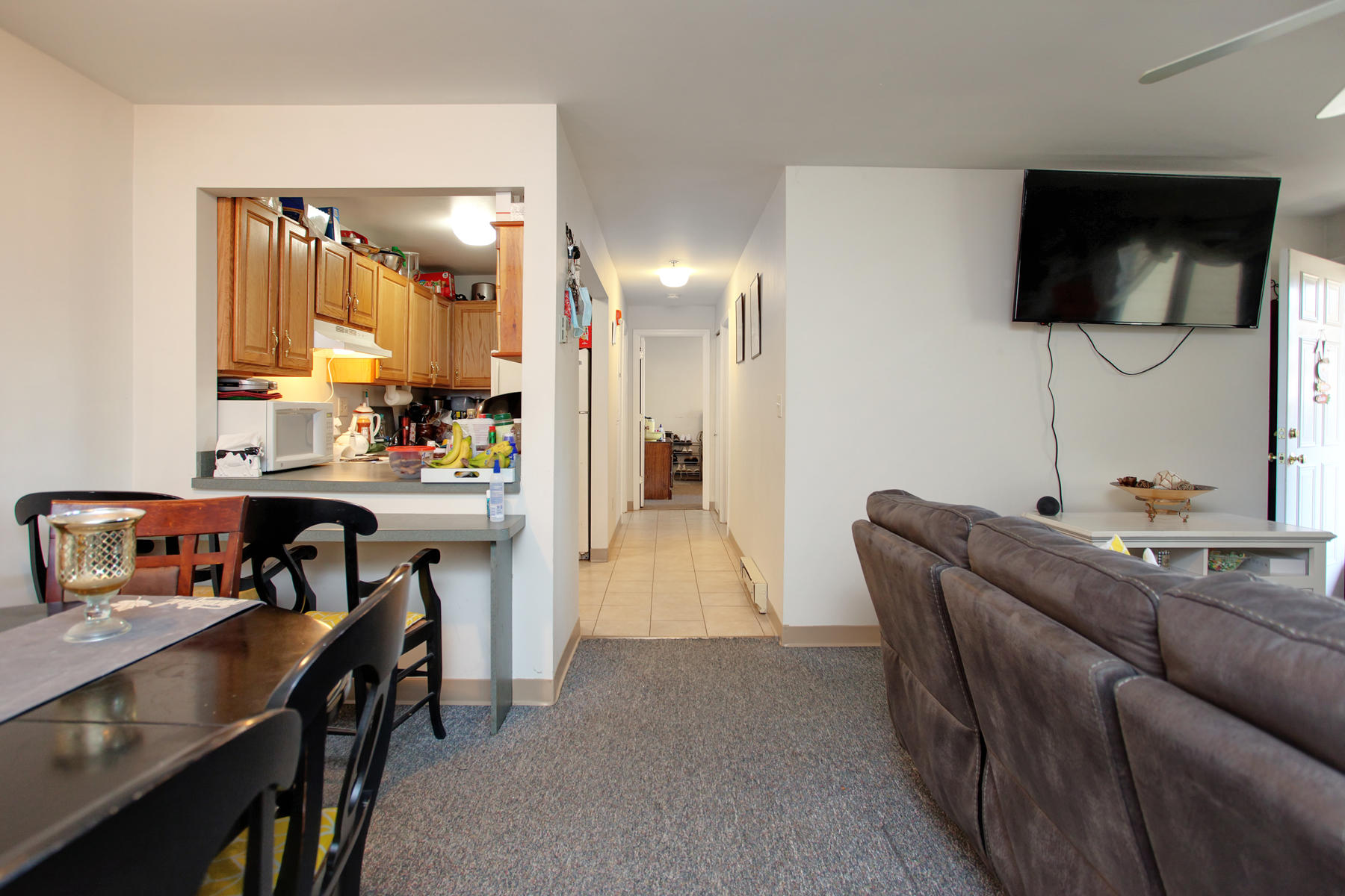 800 Bearses Way, Unit 4EF Hyannis, MA 02601 - Photo 10 of 22 a living room with furniture and a flat screen tv