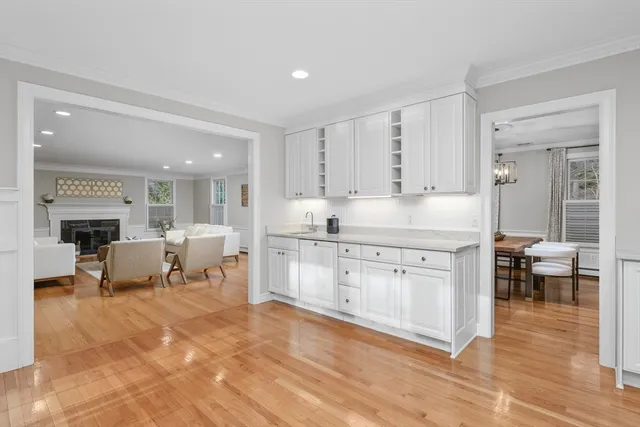 a large white kitchen with white cabinets and stainless steel appliances