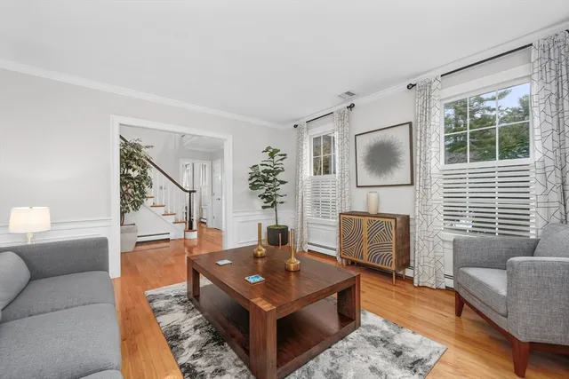 a living room with furniture a flat screen tv and a large window
