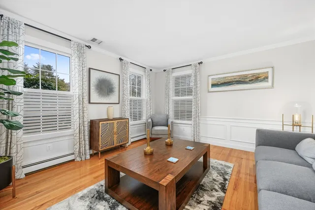 a living room with furniture a flat screen tv and a table