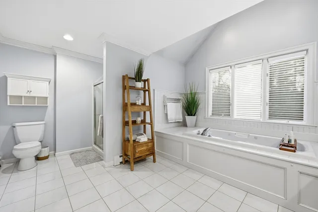 a spacious bathroom with a double vanity sink a mirror and a bathtub