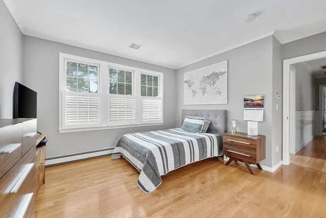 a spacious bedroom with a bed and a window